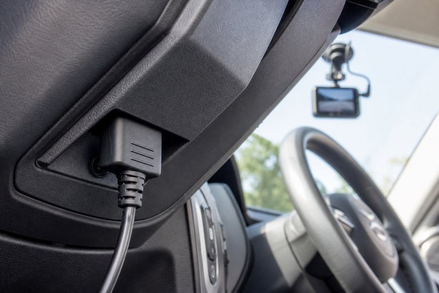 OBD-II plug-in tracker and dash cam in a car
