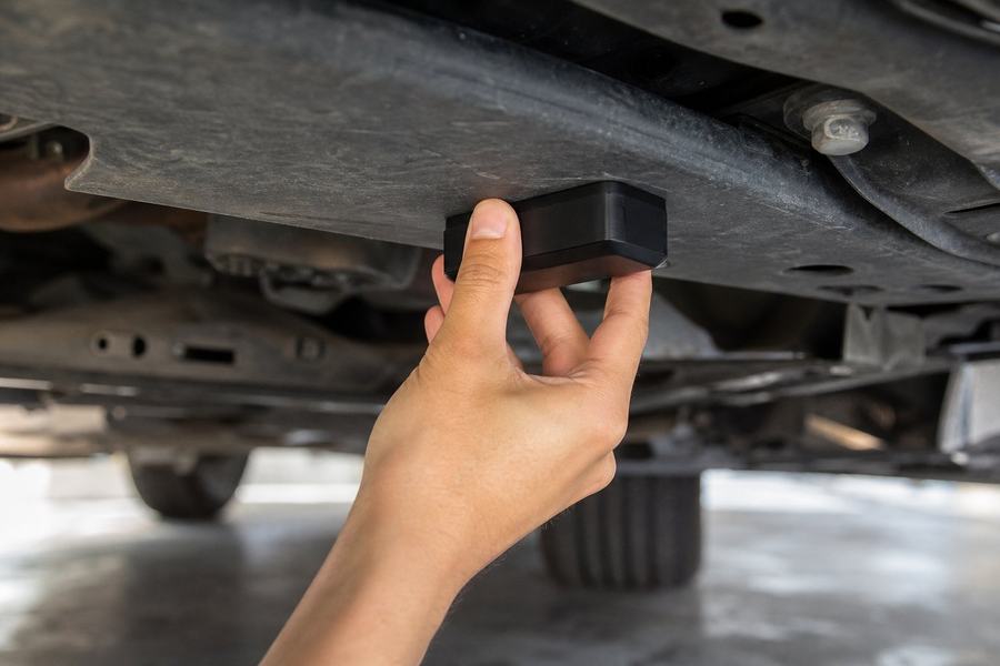 Magnetic GPS tracker attached under a vehicle